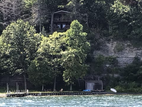 The cottage perched on the cliff with beach below