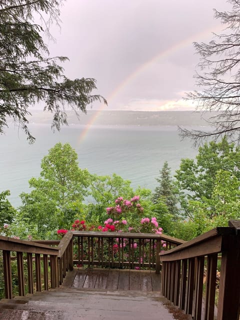 View from porch - a rainbow at the end of a summer rain over the lake