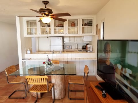 Standing in front of living room furnishings looking  to the kitchen