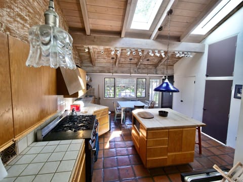 Kitchen. Older part of house. Counter tops/cabinets/floor tiles show age.