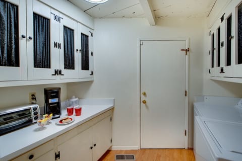 Butler pantry includes coffee maker, toaster, juicer, and washer/dryer.