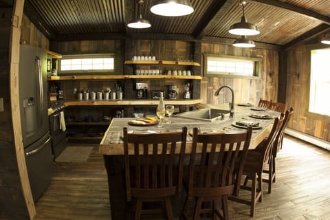 Kitchen - open shelving.  stove, refrig, micro & dish washer.  Farm house sink.