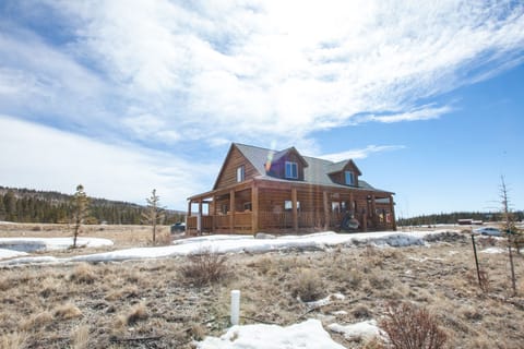 View of the front of the house with wrap around deck and hot tub