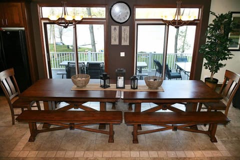 Dining area with deck beyond sliding doors and Bristol Lake beyond.