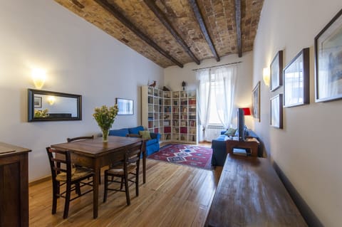 Dining table and living room with sofas.Original high vaulted beamed ceiling