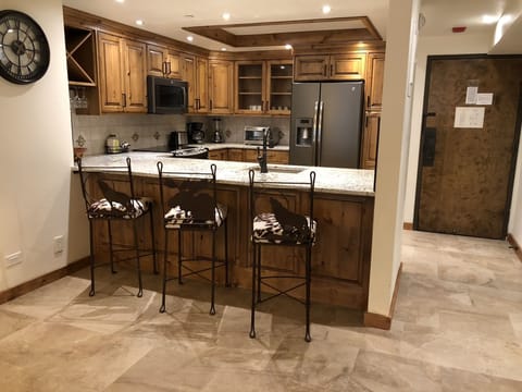 Kitchen area with bar stools