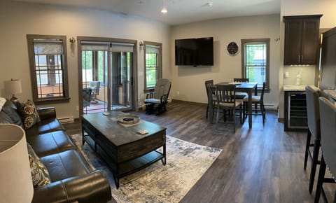 Living room is equipped with a 65" smart TV.