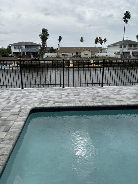 Pool and pool deck with canal