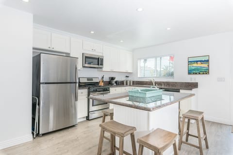 Kitchen includes an island with six bar stools, making meal prep a social affair!
