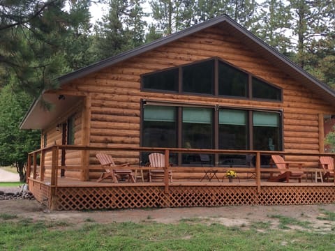 Back deck which faces river.  Large windows allow river view from den & kitchen