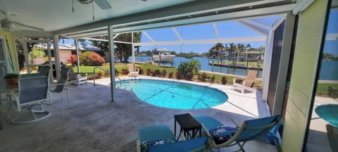 Outside screened lanai and pool overlooking dock and Dona Bay.