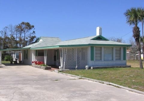 Main House -Covered patio w/concrete table & benches. Swing on covered porch.