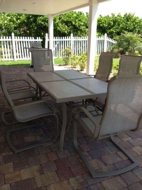 Unit #101 outside front porch next to private fenced in landscaped yard