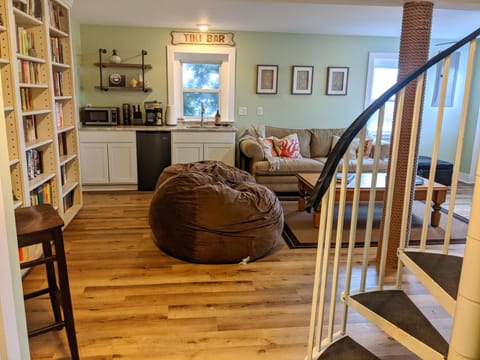 Downstairs separate cozy living rm w/ a stocked library, wet bar & big screen tv