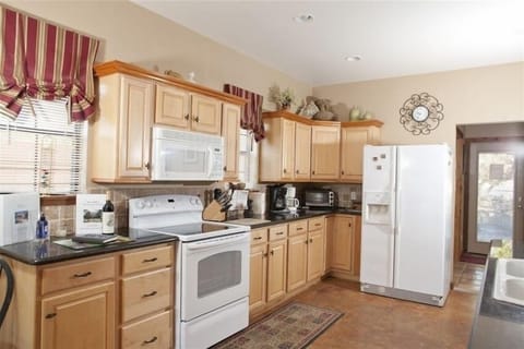 Kitchen with fridge and stove 