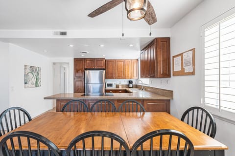The large dining table, adjacent to both kitchen and living areas, is the perfect headquarters for family meals, game night and good conversation.
                