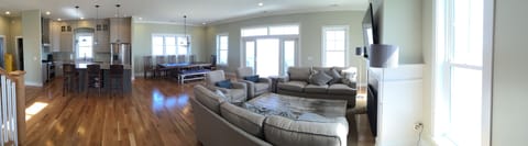 panorama of main area -:TV, dining, kitchen.   