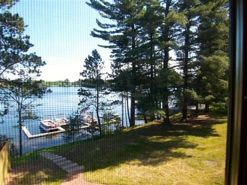 View the clear blue waters of Lake Minocqua and pier from your master suite