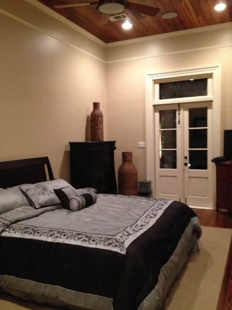 Master bedroom with french doors leading to rear patio and courtyard