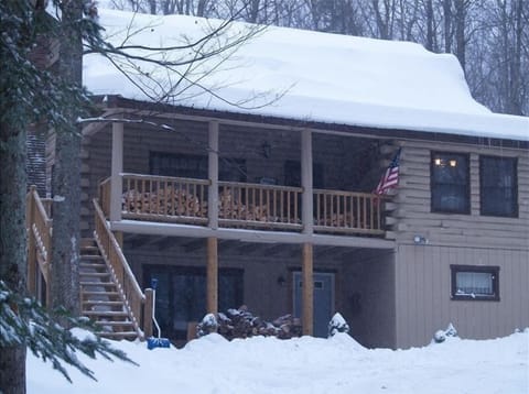 Charming Log Cabin covered in winter snow