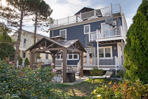 Backyard with private dining/seating area under gazebo.