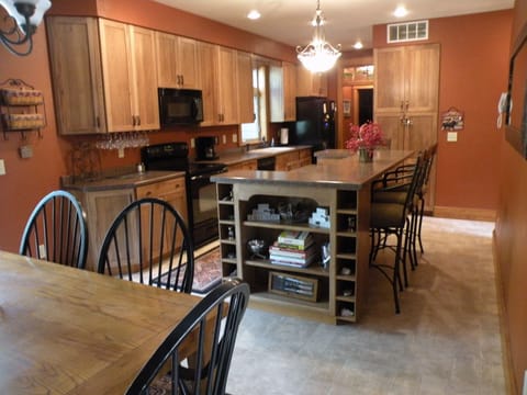 Kitchen with a bi-level bar that seats 4, lots of spices, coffee/sugar/cream