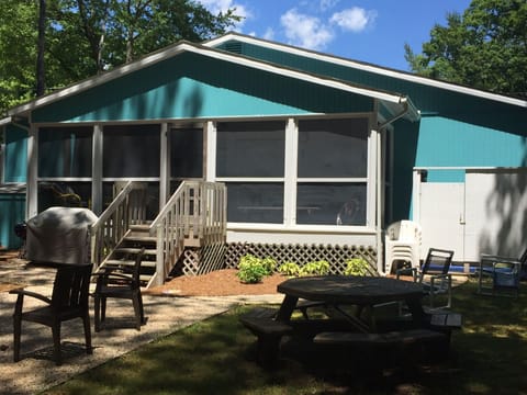 Private backyard with outdoor shower, grill, and patio.