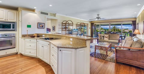 Cooking island has open view onto living room and dining area.