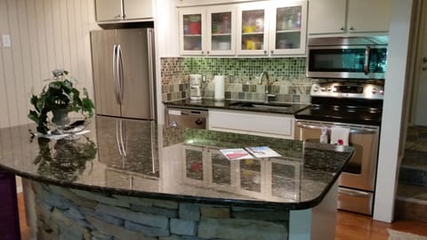 1st floor full kitchen and island.  Refrigerator, microwave, dishwasher, range