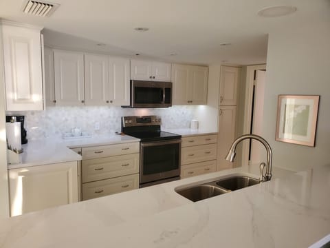 In this beautiful kitchen, you will find quality glassware, flatware and dishes