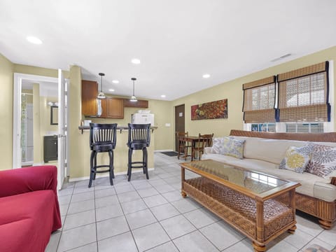 Side A larger side living area and kitchen with 2 bar seats.