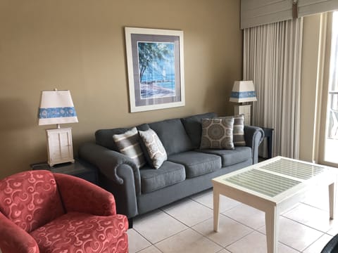 Relax in our spacious living room featuring balcony access and a flat screen TV!