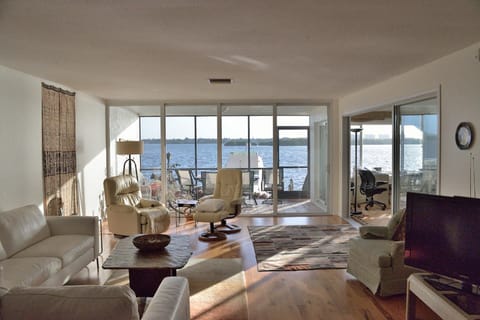 Living room with den to side.  Sweeping bay front views.