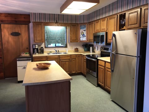 Kitchen with new stainless steel appliances.