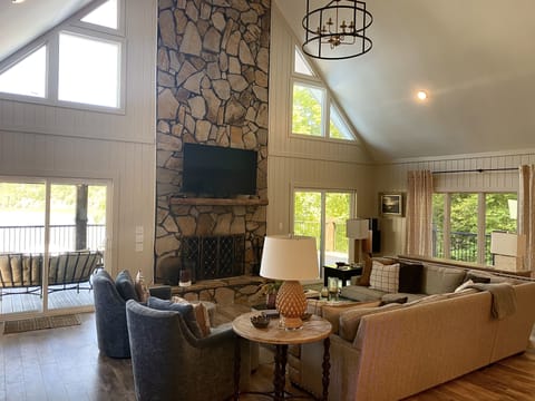 Greatroom with sectional sofa, club chairs, fireplace and 65" TV