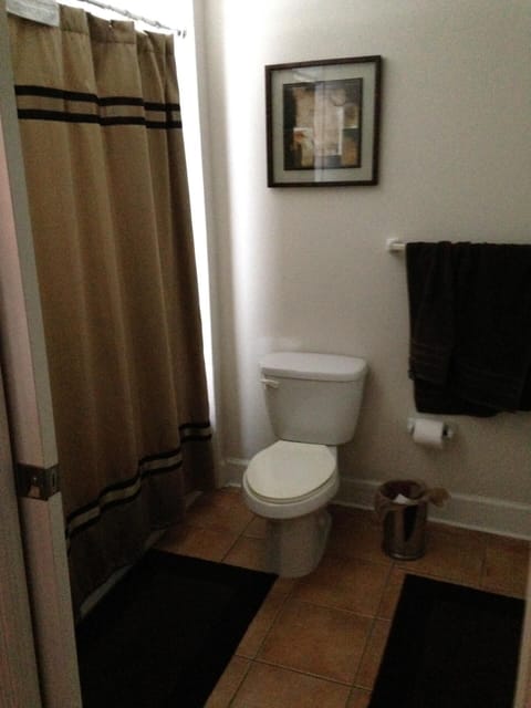 Full bath with shower/tub combo and two sinks.