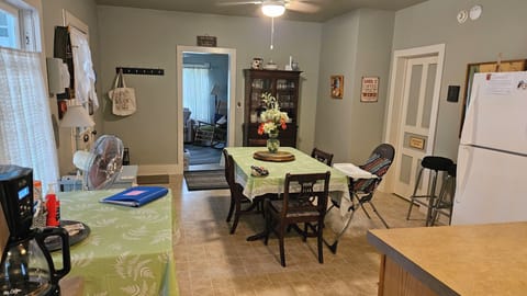 Kitchen dining area - from sink area. Doors to LR, bathroom and front porch.