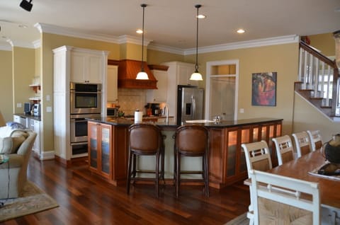 Bar height island with lighted cabinetry