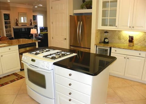 Kitchen with gas stove, microwave, undercounter beverage fridge, and full fridge