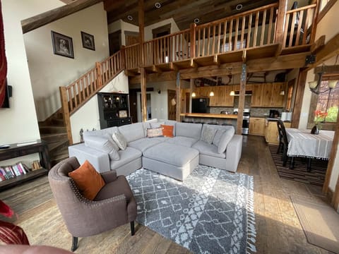 Living room with kitchen and open loft above, 8/28/22