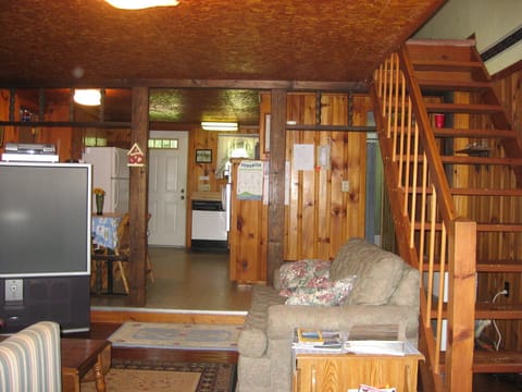 Living room and kitchen from the deck door, stairs lead to master bedroom