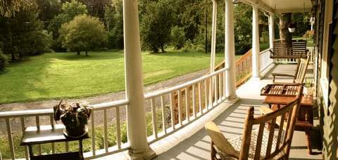 Front porch looking out to large yard & creek 