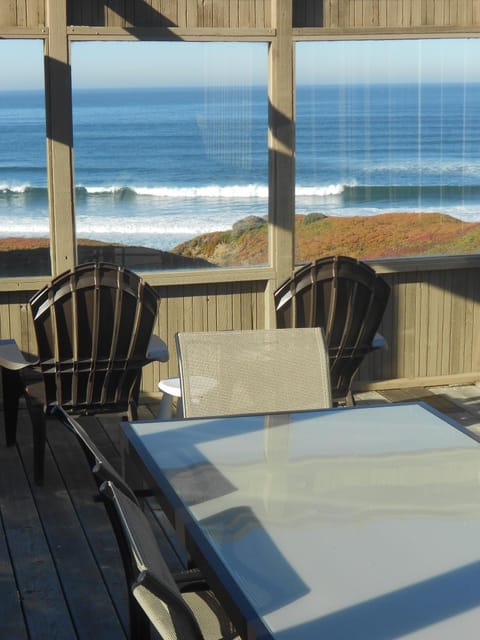 Waves crashing in front of house.