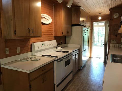 Kitchen in main house including electric stovetop/oven and refrigerator