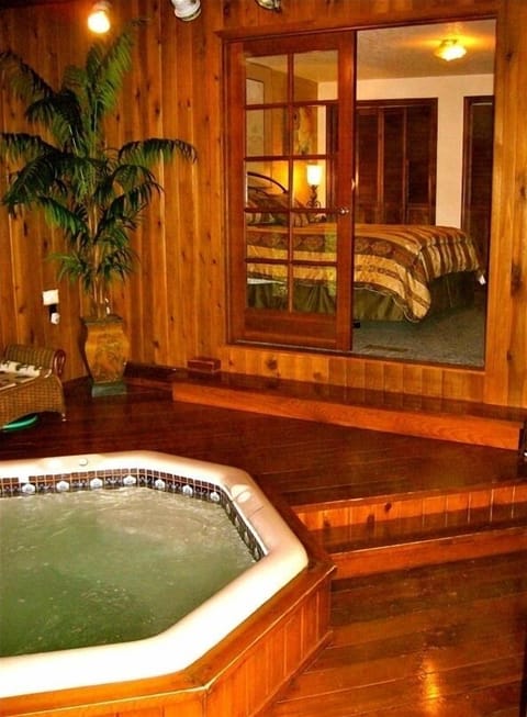 Relax in the indoor hot tub with cedar flooring after a long day at the beach!