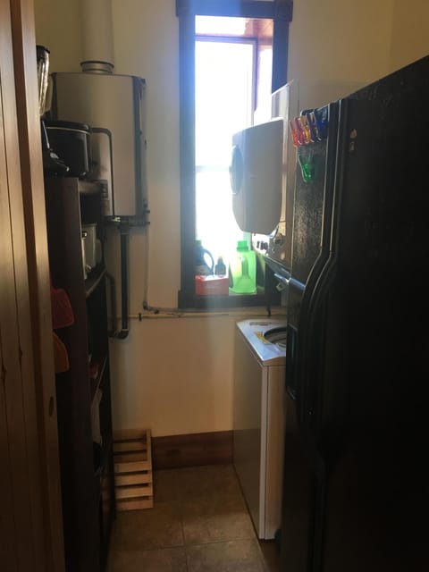 Pantry houses refrigerator, small kitchen appliances & stackable washer & dryer