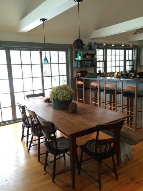 Harvest table overlooking the Mad River seats 8-12.  Hot tub is on the back porch