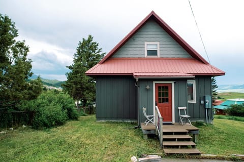 Back of house off alley. Parking area.