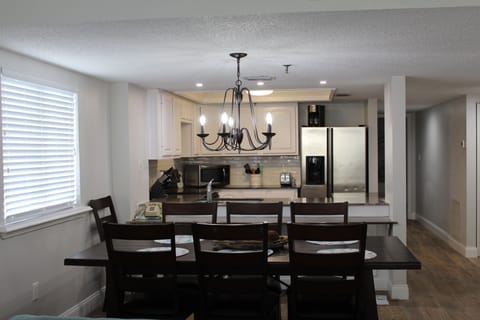 LARGE DINING ROOM TABLE WITH UP TO 8 CHAIRS AND A LEAF CAN BE INSERTED