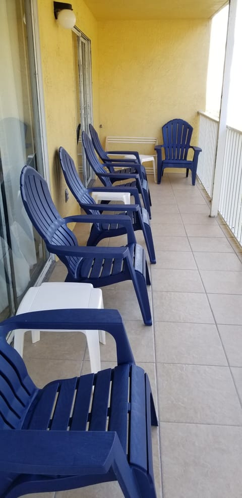 6 CHAIRS, 3 SIDE TABLES AND FOLDING RACK FOR WET SUITS ON THE LARGE BALCONY